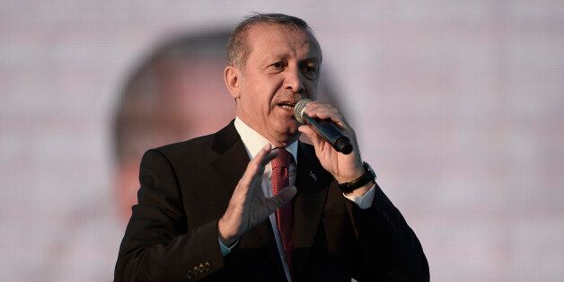 ISTANBUL, TURKEY - MAY 30: Turkey's President Tayyip Erdogan addresses his supporters during a ceremony to mark the 562nd anniversary of the conquest of the city by Ottoman Turks on May 30, 2015 in Istanbul, Turkey. Erdogan has reportedly been criticized by the opposition parties for campaigning in favor of the ruling Justice and Development Party (AKP), a party he co-founded, even though as head of state the constitution bars him from party politics. Turkey will hold a general election on June 7, 2015 to elect the 550 members of the Grand National Assembly. (Photo by Gokhan Tan/Getty Images)
