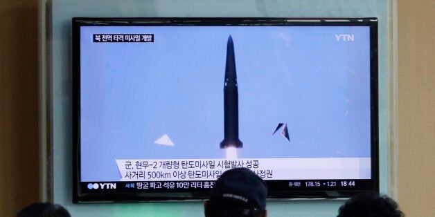 People watch a TV news program showing South Korea's missile test at Seoul Railway Station in Seoul, South Korea, Wednesday, June 3, 2015. South Korea on Wednesday successfully test-fired a domestically built ballistic missile that can hit all of North Korea, an official said. The letters on the screen read "South Korea successfully test-fired a domestically built ballistic missile that can hit all of North Korea." (AP Photo/Ahn Young-joon)