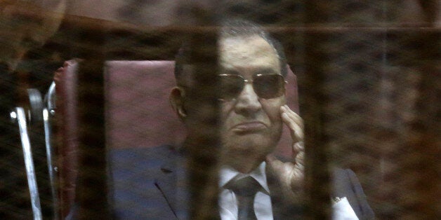 Former Egyptian President Hosni Mubarak, attends with his two sons Gamal Mubarak, and Alaa Mubarak, the verdict in the corruption case dubbed by the Egyptian media as the "presidential palaces" affair concerning charges that Mubarak and his two sons embezzled millions of dollars' worth of state funds over the course of a decade in a courtroom in Cairo, Egypt, Saturday, May 9, 2015. Egypt's deposed leader Hosni Mubarak and his two sons were sentenced Saturday to three years in prison and a fine in a retrial on corruption charges they faced earlier. It wasn't immediately clear whether it will include time he's already served since his country's 2011 revolt. (AP Photo/Hassan Ammar)