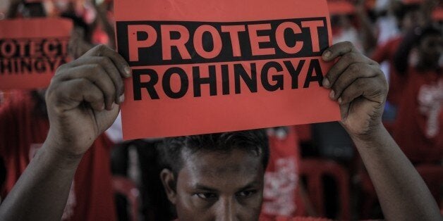 Ethnic Rohingya refugees from Myanmar residing in Malaysia hold placards during a rally over the current Rohingya crisis at a