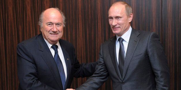 FILE - Russian Prime Minister Vladimir Putin, right, shakes hands with FIFA President Joseph Blatter after Russia was announced as the host for the 2018 soccer World Cup in Zurich, Switzerland. FIFA has cleared Russia and Qatar of any wrongdoing in their winning bids for the next two World Cups. (AP Photo/Kurt Schorrer, Pool)