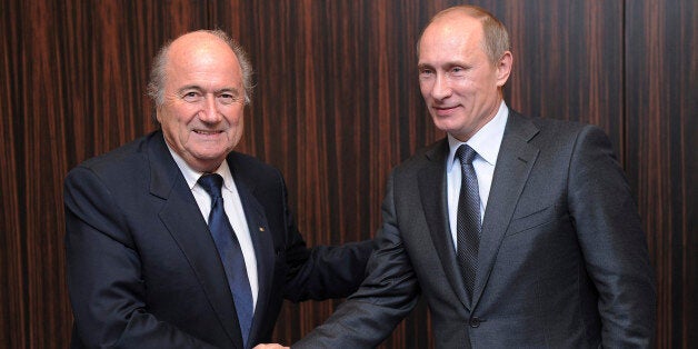 FILE - Russian Prime Minister Vladimir Putin, right, shakes hands with FIFA President Joseph Blatter after Russia was announc