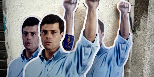 FILE - In this July 23, 2014 file photo, life-size cardboard cutouts of opposition leader Leopoldo Lopez, placed by his suppo