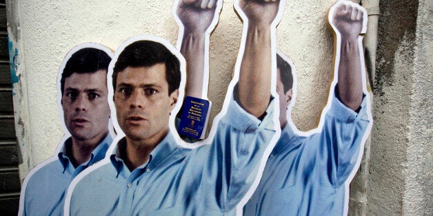 FILE - In this July 23, 2014 file photo, life-size cardboard cutouts of opposition leader Leopoldo Lopez, placed by his supporters, stand outside the Justice Palace as his trial begins in Caracas, Venezuela. Lopez gave an impassioned speech in court Tuesday, Nov. 18, 2014 saying he would waive his right to be present at hearings until an appeals court rules on whether to comply with U.N. calls for his freedom. Lopez has been jailed since February for his role in the street demonstrations that shook the country earlier this year. He faces charges of inciting violence. (AP Photo/Fernando Llano, File)