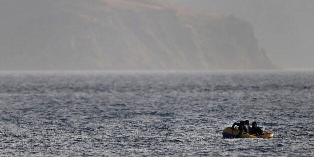 Migrants from Pakistan trying to cross from Turkey to Greece, row their dinghy as they approach the island of Kos, Greece, Tuesday, June 2, 2015. Greece and Italy are the main points of entry into the European Union for refugees and economic migrants from the Middle East and Africa hoping to reach other European Union countries. (AP Photo/Petros Giannakouris)