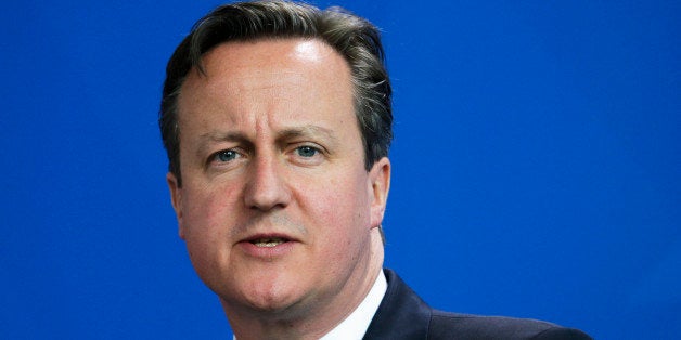 British Prime Minister David Cameron briefs the media during a news conference with German Chancellor Angela Merkel after meeting at the chancellery in Berlin, Germany, Friday, May 29, 2015. (AP Photo/Markus Schreiber)