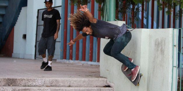 In this Thursday, July 25, 2013 photo, Yojany Perez, 23, competes at a skateboarding event at the Ciudad Deportiva sporting complex in Havana, Cuba. There's no formal organization or leadership. Cuba's skaters just meet casually at homes before skating off in a pack to whatever park, plaza, fountain or monument offers challenging features like ramps, steps, benches or holes to jump.. (AP Photo/Franklin Reyes)
