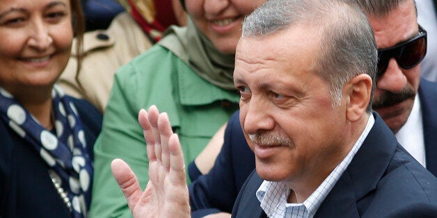 Turkeyâs President Recep Tayyip Erdogan waves to onlookers after he voted at a polling station in Istanbul, Turkey, Sunday,
