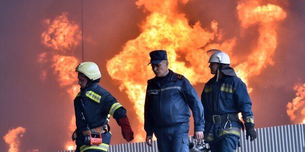 Ukrainian firefighters work to extinguish a fire at a fuel depot in the village of Kryachki, some 30 km southwest from Kiev, on June 9, 2015. Ukraine urgently evacuated hundreds of residents on June 9 from the site of a series of fuel depot blasts near Kiev that set off a ferocious fire and left several people missing and at least one confirmed dead. The defence ministry said it was also taking emergency measures to prevent the flames engulfing a nearby military airbase which has MiG-29 fighter jets and munitions on site. AFP PHOTO / SERGEI SUPINSKY (Photo credit should read SERGEI SUPINSKY/AFP/Getty Images)
