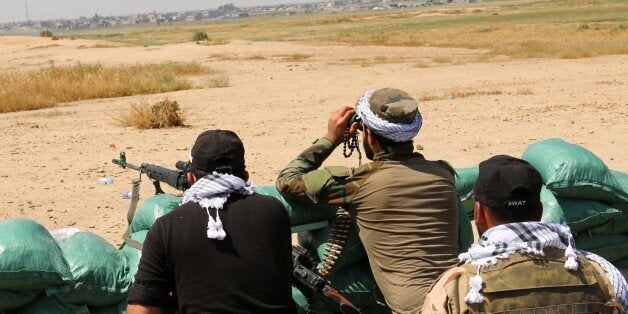 Iraqi Kurdish Peshmerga forces and al-Hashd al-Shaabi factions hold a position close to the village of Bashir in the Qatqa Daquq district (45 km south of Kirkuk) on April 18, 2015 as they launched an operation aiming to recapture nearby villages from the Islamic State (IS) group. AFP PHOTO / MARWAN IBRAHIM (Photo credit should read MARWAN IBRAHIM/AFP/Getty Images)