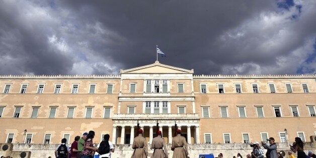 Evzoni presidental guards walk in front of the Greek parliament in Athens on June 8, 2015. Greece is going to have to make 't