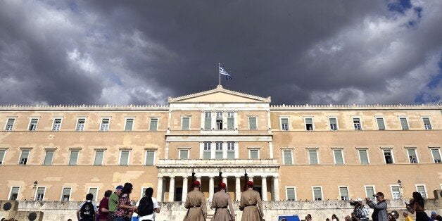 Evzoni presidental guards walk in front of the Greek parliament in Athens on June 8, 2015. Greece is going to have to make 'tough' choices as it implements reforms to tackle its debt crisis, US President Barack Obama said after a G7 summit. Athens will have to make 'tough decisions' that will be 'good for the long term', stressed Obama following a gathering of world leaders where the tottering Greek economy was high on the agenda. AFP PHOTO / LOUISA GOULIAMAKI (Photo credit should read LOUISA GOULIAMAKI/AFP/Getty Images)