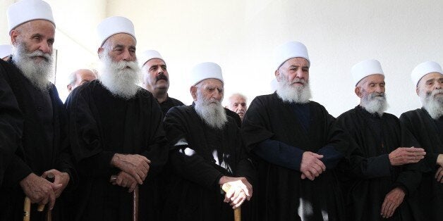 Druze sheikhs attend the funeral of Lebanese army First lieutenant Firas Mahmud al-Hakim, who was killed during clashes with Islamist gunmen in the northern city of Tripoli, in the town of Mesherfeh near Bhamdun, in the mountains southeast of Beirut, on October 26, 2014. Lebanese troops fought a fierce and deadly battle with Islamist gunmen in the historic market of second city Tripoli, in clashes that devastated parts of the popular tourist site. AFP PHOTO/ANWAR AMRO (Photo credit should read ANWAR AMRO/AFP/Getty Images)