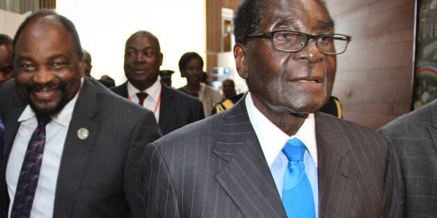 Zimbabwe's President Robert Mugabe, right, arrives for the heads of state meeting of the annual African Union (AU) summit, held at the AU headquarters in Addis Ababa, Ethiopia Friday, Jan. 30, 2015. African leaders Friday appointed the 90-year-old Zimbabwean President Robert Mugabe, who has ruled his country since 1980, as the new chairman of the 54-nation African Union, succeeding Mauritania's President Mohamed Ould Abdel Aziz. (AP Photo)