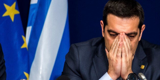 Greek Prime Minister Alexis Tsipras pauses before answering questions during a media conference after an EU summit in Brussels on Thursday, Feb. 12, 2015. European Union leaders on Thursday said the full respect of the planned weekend cease-fire in eastern Ukraine will be essential before there could be a change in the sanctions regime imposed on Moscow. (AP Photo/Geert Vanden Wijngaert)