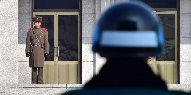 A North Korean soldier (L) and a South Korean soldier (R) stand opposite each other at the truce village of Panmunjom in the Demilitarized Zone dividing the two Koreas on February 4, 2015. North Korea appeared to rule out any resumption of dialogue with the United States, threatening to react to any US 'war of aggression' with nuclear strikes and cyber warfare. AFP PHOTO / JUNG YEON-JE (Photo credit should read JUNG YEON-JE/AFP/Getty Images)