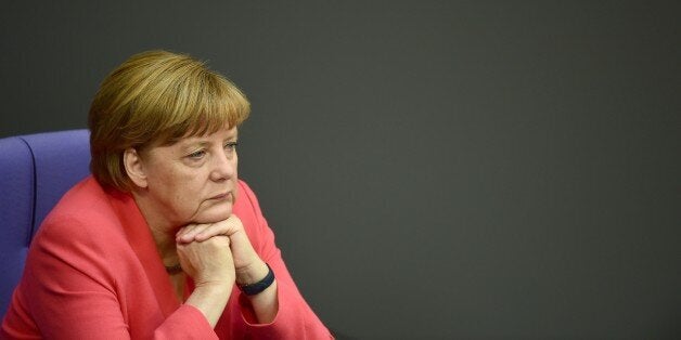 German Chancellor Angela Merkel is pictured before addressing the members of parliament on her positions ahead of an EU summit and on Greece rescue efforts at the Bundestag lower house of parliament in Berlin on June 18, 2015. Merkel said she was convinced it was still possible to reach an accord with Greece on its crippling debt crisis, ahead of crunch EU meeting on June 25. AFP PHOTO / JOHN MACDOUGALL (Photo credit should read JOHN MACDOUGALL/AFP/Getty Images)