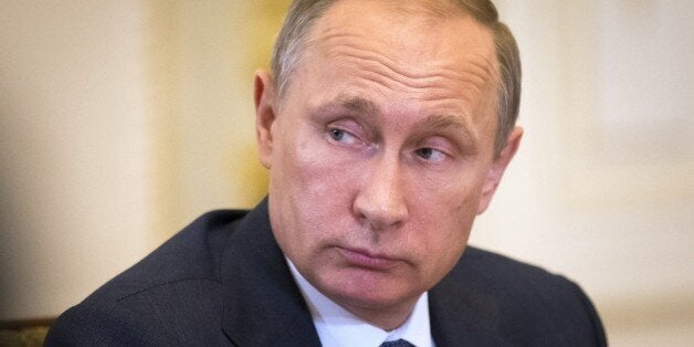 Russian President Vladimir Putin listens to the Chinese Vice Premier during talks at the Saint Petersburg International Investment Forum in Saint Petersburg, Russia, on June 18, 2015. AFP PHOTO / POOL / ALEXANDER ZEMLIANICHENKO (Photo credit should read ALEXANDER ZEMLIANICHENKO/AFP/Getty Images)