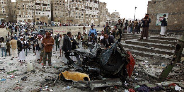 Yemenis surround the wreckage of a vehicle outside the Kobbat al-Mehdi Shiite mosque in the capital Sanaa on June 20, 2015, after a car bomb targeting the area killed two people. The explosion in Sanaa, controlled by Iran-backed Shiite Huthi rebels, went off outside the mosque as Shiite Muslims emerged from midday prayers, witnesses and security sources said. AFP PHOTO / MOHAMMED HUWAIS (Photo credit should read MOHAMMED HUWAIS/AFP/Getty Images)