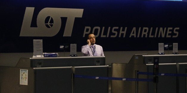 A Polish Airlines employee talks on the phone in a darkened ticket counter waiting for flight 003 from Warsaw, a Boeing 787 airplane, at Chicago's O'Hare International Airport Wednesday, Jan. 16, 2013. The FAA grounded all Boeing 787 Dreamliner airplanes pending safety checks of the planes lithium batteries and passengers ticketed on the return flight were rebooked on other airlines. (AP Photo/Charles Rex Arbogast)