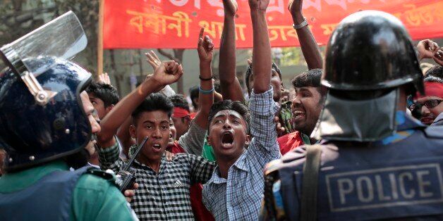 Supporters of National Transport Workers League, a wing of the ruling Awami League party shout slogans in front of the office of opposition Bangladesh Nationalist Party (BNP) during a demonstration against the ongoing nationwide blockade and strike called by the opposition in Dhaka, Bangladesh, Monday, Feb. 9, 2015. At least 63 people have lost their lives due to violence in the nationwide transportation blockade that began Jan.6, to pressure Prime Minister Sheikh Hasina to resign and announce new elections. (AP Photo/ A.M. Ahad)