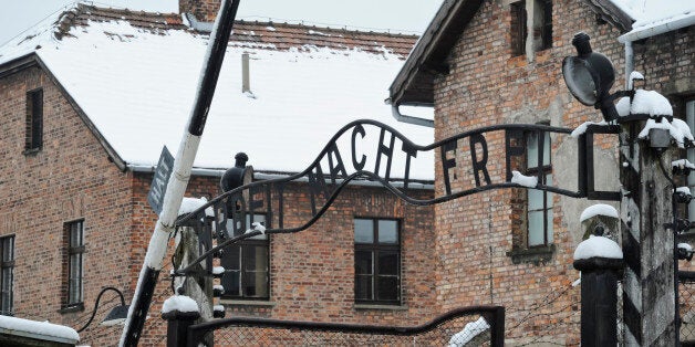 The "Arbeit Macht Frei" (Work Sets you Free) sign above the entrance gate of the Auschwitz Nazi death camp, is backdropped by