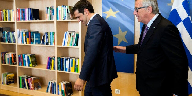 Greek Prime Minister Alexis Tsipras, left, is greeted by European Commission President Jean-Claude Juncker prior to a meeting at EU headquarters in Brussels on Wednesday, June 24, 2015. Eurozone finance ministers meet Wednesday to discuss the Greek bailout. (Julien Warnand/Pool Photo via AP)