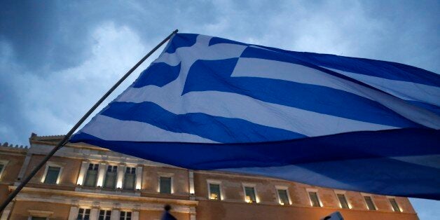 Demonstrators gather during a rally organized by supporters of the YES vote for the upcoming referendum in front of the Greek Parliament in Athens, Tuesday, June 30, 2015. At midnight central Europe-time on Tuesday, the country is set to become the first developed nation to miss a debt repayment to the International Monetary Fund, as Greece sinks deeper into a financial emergency that has forced it put a nationwide lockdown on money withdrawals. (AP Photo/Petros Karadjias)