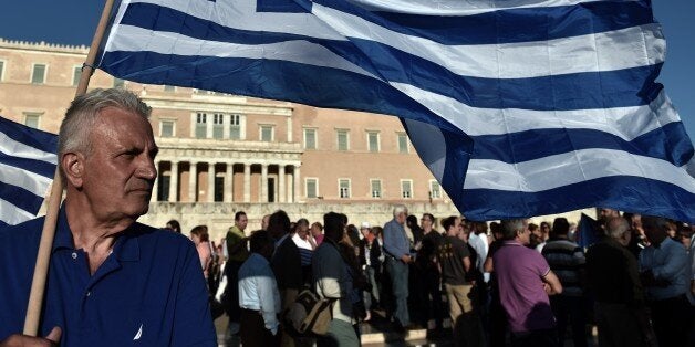 Protesters demonstrate during a pro-European demonstration in front of the Greek parliament in Athens on June 22, 2015. Greece's international lenders raised hopes for a vital bailout agreement this week to save Athens from default and a possible euro exit, despite warning no deal was likely at an emergency summit. AFP PHOTO / ARIS MESSINIS (Photo credit should read ARIS MESSINIS/AFP/Getty Images)