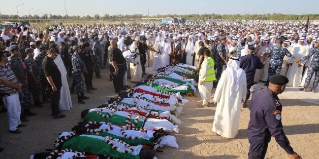 Mourners pray over the bodies of the victims of the Al-Imam Al-Sadeq mosque bombing, during a mass funeral at Jaafari cemetery in Kuwait City on June 27, 2015. The interior ministry said in a statement that 26 people and the suicide bomber were killed and 227 others were wounded in one of the country's worst bombings and its first ever on a mosque. AFP PHOTO / YASSER AL-ZAYYAT (Photo credit should read YASSER AL-ZAYYAT/AFP/Getty Images)