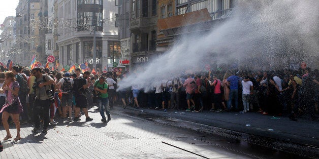 Turkish police use a water canon to disperse participants of a Gay Pride event in support of Lesbian, Gay, Bisexual and Transsexual (LGBT) rights in Istanbul, Turkey, Sunday, June 28, 2015. Turkish police have used water cannons and tear gas to clear gay pride demonstrators from Istanbul's central square. Between 100 and 200 protestors were chased away from Taksim Square on Sunday after a police vehicle fired several jets of water to disperse the crowd. It wasn't immediately clear why the police intervened to push the peaceful if noisy protest away from the area. (AP Photo/Emrah Gurel)