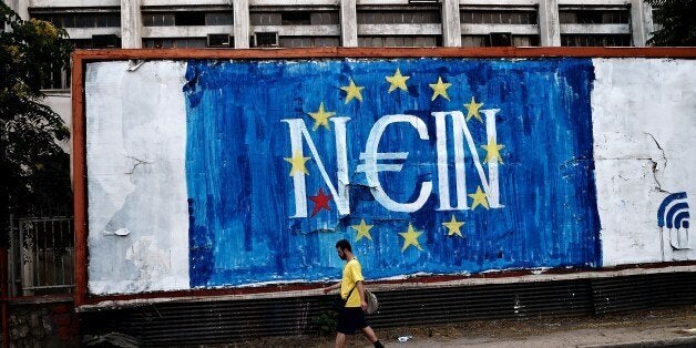 A man walks past a graffitti with a EU flag reading in German 'NO' concerning Greece's referendum on the latest offer of a debt deal by the country's EU-IMF creditors, in Athens on June 28, 2015. Greece will work with the European Central Bank on formulating a response to the cash crisis facing its banks before they are due to open on June 29, Varoufakis said Sunday. Speaking shortly before an emergency gathering of Greece's systemic stability council, he declined to say whether the government intended to introduce capital controls. AFP PHOTO / ARIS MESSINIS (Photo credit should read ARIS MESSINIS/AFP/Getty Images)