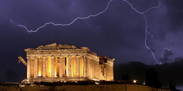 Athens, GREECE: The ancient Greek Parthenon temple, atop the Acropolis hill overlooking Athens, is framed by a lightning bolt during a thunderstorm that broke out in the Greek capital, late 9 October 2006. Greece has experienced stormy weather since the weekend, with two regions now placed in a state of emergency because of flood-related problems that damaged homes and disrupted transport. AFP PHOTO ARIS MESSINIS (Photo credit should read ARIS MESSINIS/AFP/Getty Images)