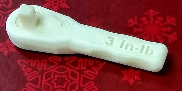 Edited NASA image of an identical duplicate (how's that for tautological?) wrench printed with a 3D printer as the wrench, al