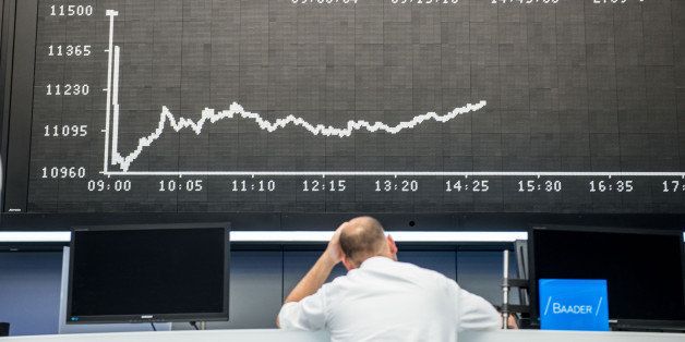 FRANKFURT AM MAIN, GERMANY - JUNE 29: A trader stands under the day's performance graph showing a sharp drop of the German DAX stock market index early today and a partial recovery later on the day after the European Central Bank announced it would not extend emergency funding to Greece on June 29, 2015 in Frankfurt, Germany. Meanwhile the Greek government ordered cash machines turned off and a tightening on the flow of capital in an effort to staunch citizens' withdrawals. (Photo by Thomas Lohnes/Getty Images)