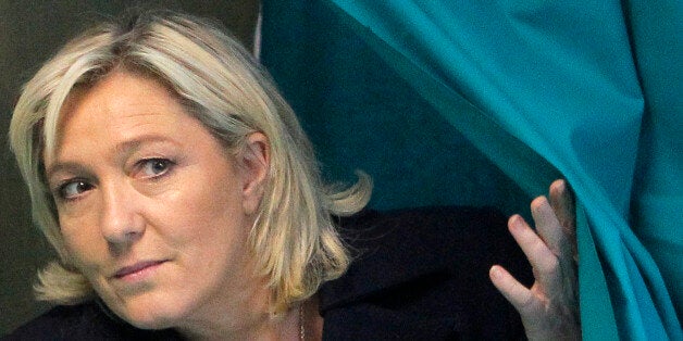 French far-right leader and National Front Party, Marine Le Pen, exits from a polling booth after voting for the second round of local elections, Sunday, March 29, 2015, in Henin-Beaumont, northern France. French voters are choosing members of local councils in runoff elections Sunday seen as a test for the far right National Front, which is expanding its presence in French politics. (AP Photo/Michel Spingler)