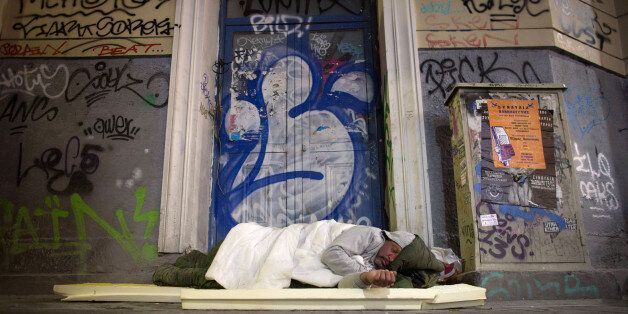 ATHENS, GREECE - JANUARY 21: A homeless man sleeps in a doorway on the streets of Athens ahead of this weekend general election on January 21, 2015 in Athens, Greece. According to the latest opinion polls, the left-wing Syriza party are poised to defeat Prime Minister Antonis Samaras' conservative New Democracy party in the election, which will take place on Sunday. European leaders fear that Greece could abandon the Euro, write off some of its national debt and put an end to the country's austerity by renogotiating the terms of its bailout if the radical Syriza party comes to power. Greece's potential withdrawal from the eurozone has become known as the 'Grexit'. (Photo by Matt Cardy/Getty Images)