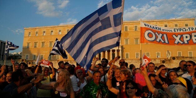 Supporters of a NO vote in the upcoming referendum, gather during a rally at Syntagma square in Athens Monday, June 29, 2015. Anxious Greek pensioners swarmed closed bank branches and long lines snaked at ATMs as Greeks endured the first day of serious controls on their daily economic lives ahead of a July 5 referendum that could determine whether the country has to ditch the euro currency and return to the drachma. (AP Photo/Petros Karadjias)