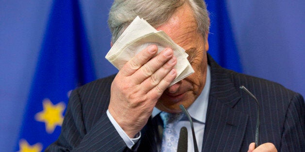 European Commission President Jean-Claude Juncker wipes his face during a media conference at EU headquarters in Brussels on Wednesday, July 1, 2015. The eurozone's finance ministers are set to weigh a last-minute Greek proposal for a new aid program, submitted Tuesday afternoon, in a conference call which will take place on Wednesday. (AP Photo/Virginia Mayo)