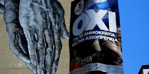 Hands painted on the wall of a building seen behind a poster for a NO vote in the upcoming referendum, in central Athens, Wednesday, July 1, 2015. European officials and Greek opposition parties have been adamant that a "No" vote on Sunday will mean Greece will leave the euro and possibly even the EU. The government rejects the argument as scaremongering, and says dismissing creditor demands will mean the country is in a better negotiating position. (AP Photo/Petros Karadjias)