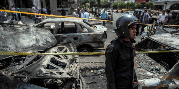 An Egyptian policeman stands guard at the site of a bombing that killed Egypts top prosecutor, Hisham Barakat, in Cairo, Egyp