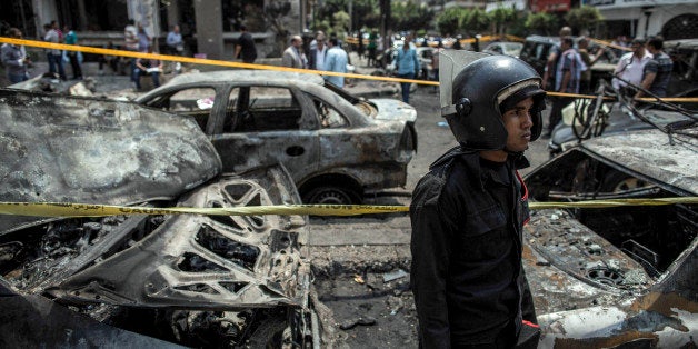 An Egyptian policeman stands guard at the site of a bombing that killed Egypts top prosecutor, Hisham Barakat, in Cairo, Egypt, Monday, June 29, 2015. The car bomb killed Barakat, in the first assassination of a top official in the country in a quarter century, marking an apparent escalation by Islamic militants in their campaign of revenge attacks for a 2-year-old crackdown on the Muslim Brotherhood. Barakat led the wide-scale prosecution against figures from the Brotherhood and other Islamists, including former President Mohammed Morsi, who was ousted by the military in July 2013 (AP Photo/Eman Helal)