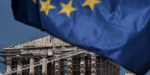 The Parthenon temple is seen behind an European Union flag in in Athens on July 2, 2015. The Greek government led by Prime M