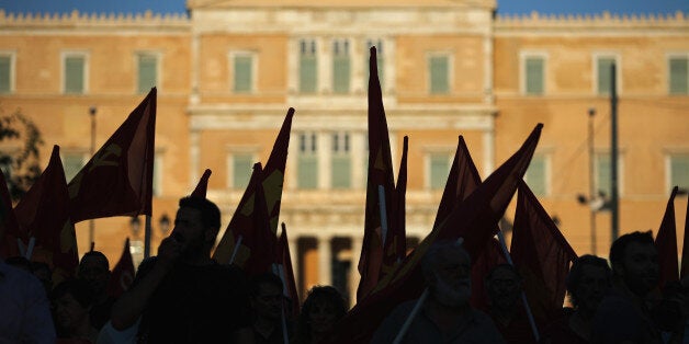 ATHENS, GREECE - JULY 02: Greek Communist Party supporters listen to speeches during a rally in Syntagma Square near the Parliament on July 2, 2015 in Athens, Greece. As people continue to queue outside banks Greek finance minister Yanis Varoufakis said that he will quit if voters don't back him up in Sunday's referendum. (Photo by Christopher Furlong/Getty Images)