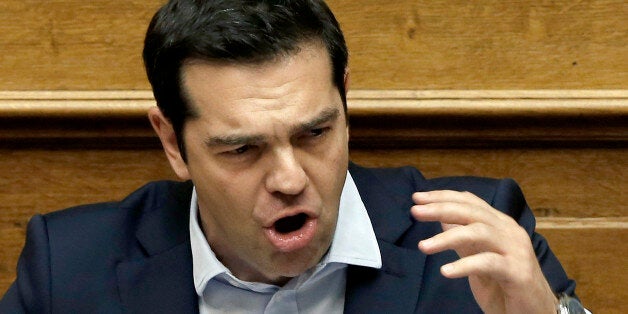 Greece's Prime Minister Alexis Tsipras delivers a speech to the lawmakers during an emergency Parliament session for the governmentâs proposed referendum in Athens, early Sunday, June 28, 2015. Greece's parliament has voted in favor of Prime Minister Tsipras' motion to hold a referendum on the country's creditor proposals for reforms in exchange for loans. Tsipras and his coalition government have urged people to vote against the deal, throwing into question the country's financial future.(AP Photo/Petros Karadjias)