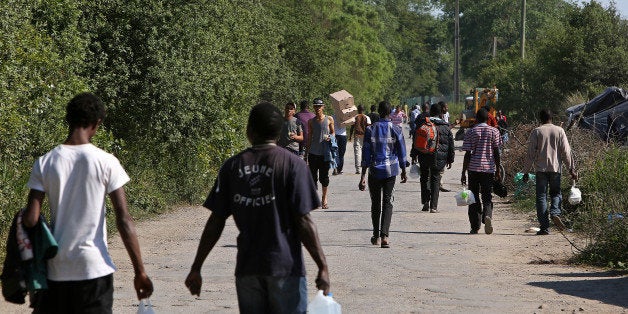 CALAIS, FRANCE - JULY 01: Migrants are seen in a make shift camp known as the 'New Jungle' on July 1, 2015 in Calais, France. Cross-channel travel has be disrupted for third day this week as MyFerryLink employees continue their industrial action. Migrants took advantage of the travel disruption by trying to board lorries bound for the UK. (Photo by Rafael Yaghobzadeh/Getty Images)