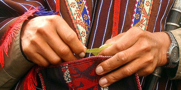 A Bolivian witch doctor asks for peace while reading the country's future on coca leaves in front of the National Congress in La Paz, Bolivia on Tuesday, May 17, 2005. (AP Photo/Dado Galdieri)