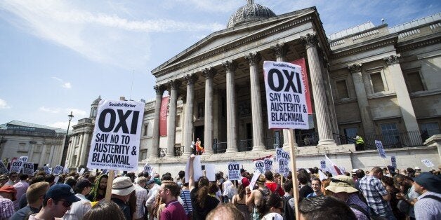 An anti-austerity demonstrators attend a rally in Trafalgar Square in central London on July 4, 2015 in solidarity with those voting 'No' in Greece's forthcoming referendum. Greece braced itself Saturday ahead of a make-or-break bailout referendum as polls showed the 'Yes' and 'No' camps neck and neck and uncertainty rose over the future of the country's battered economy. AFP PHOTO / JACK TAYLOR (Photo credit should read JACK TAYLOR/AFP/Getty Images)