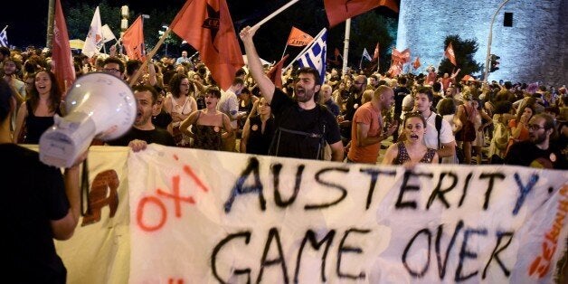 Supporters of the No vote celebrate after the results of the referendum in the northern Greek port city of Thessaloniki, Sund