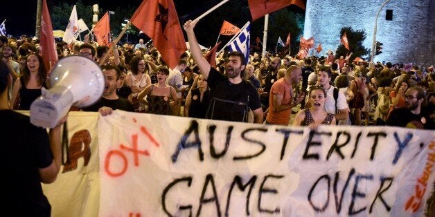 Supporters of the No vote celebrate after the results of the referendum in the northern Greek port city of Thessaloniki, Sunday, July 5, 2015. Greeks overwhelmingly rejected creditorsâ demands for more austerity in return for rescue loans in a critical referendum Sunday, backing Prime Minister Alexis Tsipras, who insisted the vote would give him a stronger hand to reach a better deal. (AP Photo/Giannis Papanikos)